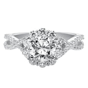 Awe-inspiring sparkle illuminates from this engagement ring featuring a shared prong set diamond halo and elegant twisted diamond band for grand effect.