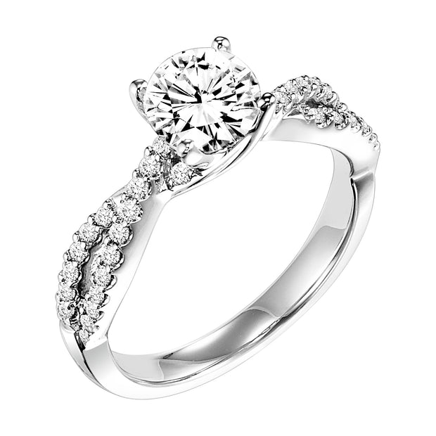 This engagement ring features a diamond prong set band with a delicate twist design elegantly leading up to the round center diamond for an alluring look