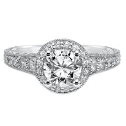 This show-stopping engagement ring is sure to impress with its diamond prong set halo and band with milgrain and engraving