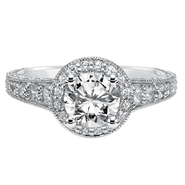 This show-stopping engagement ring is sure to impress with its diamond prong set halo and band with milgrain and engraving