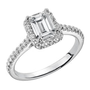 This timeless engagement ring features a diamond exquisitely enhanced with a prong set diamond halo and band