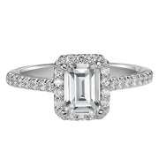 This timeless engagement ring features a diamond exquisitely enhanced with a prong set diamond halo and band