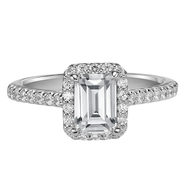 This timeless engagement ring features a diamond exquisitely enhanced with a prong set diamond halo and band