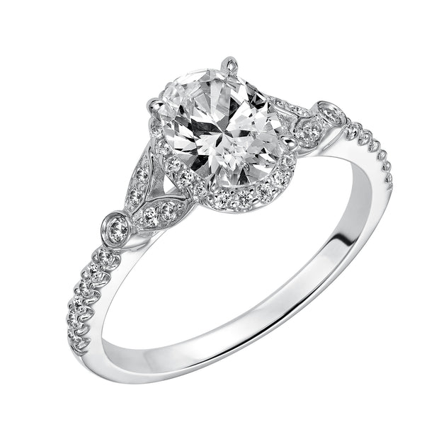 This romantic and beautiful engagement ring features an oval cut diamond accentuated by a prong set diamond halo and petal-inspired band design