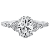 This romantic and beautiful engagement ring features an oval cut diamond accentuated by a prong set diamond halo and petal-inspired band design