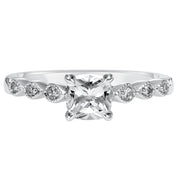 Dazzling with its intricately designed diamond band, this engagement ring is distinct yet enchanting