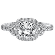 This whimsically styled engagement ring sparkles with its filigree and diamond halo and diamond prong set floral-inspired band