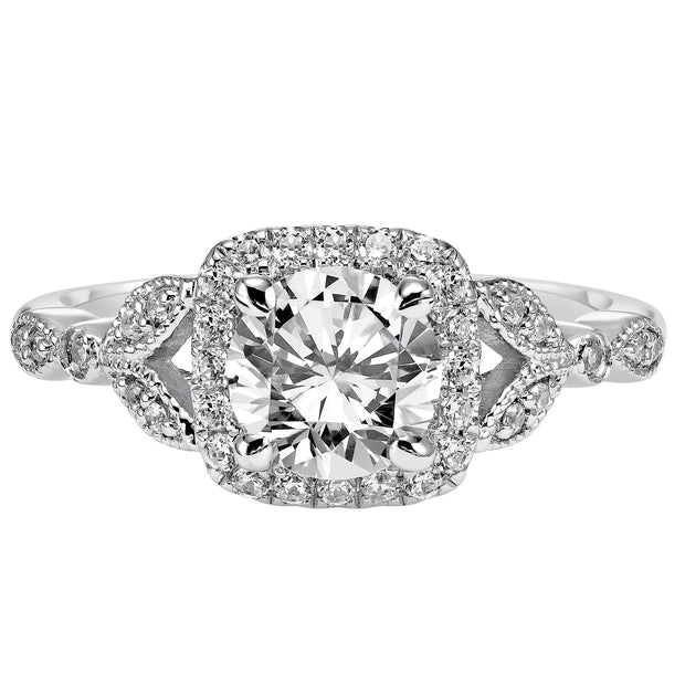 This whimsically styled engagement ring sparkles with its filigree and diamond halo and diamond prong set floral-inspired band