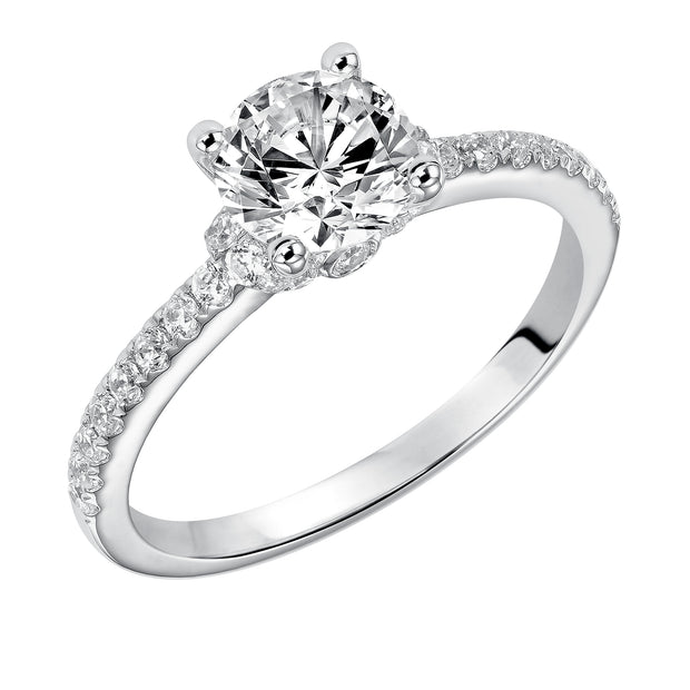 This engagement ring celebrates classic elegance with its delicate diamond prong set band and diamond tiara accent
