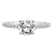 This engagement ring celebrates classic elegance with its delicate diamond prong set band and diamond tiara accent