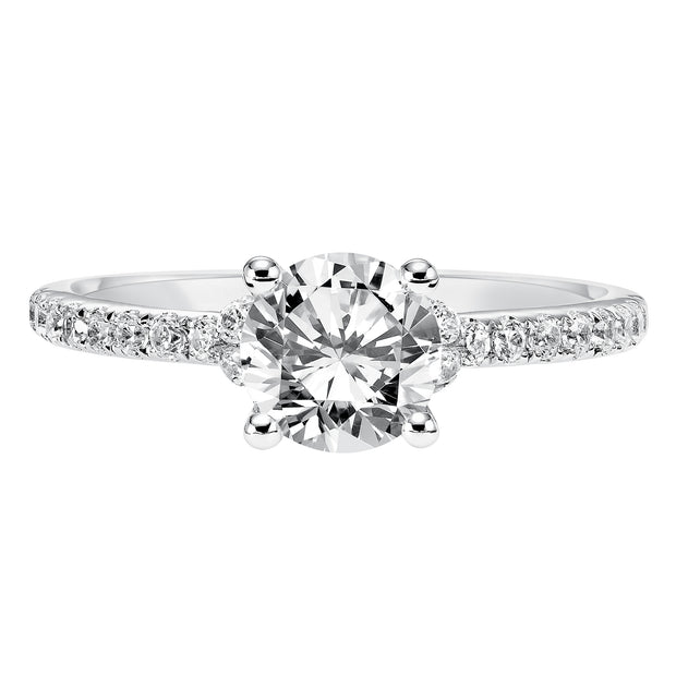 This engagement ring celebrates classic elegance with its delicate diamond prong set band and diamond tiara accent