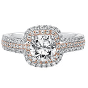 This engagement ring is truly breathtaking featuring both rose and white gold in its prong set diamond double halo and three row band design